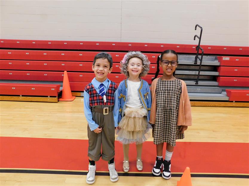 three students in the gym